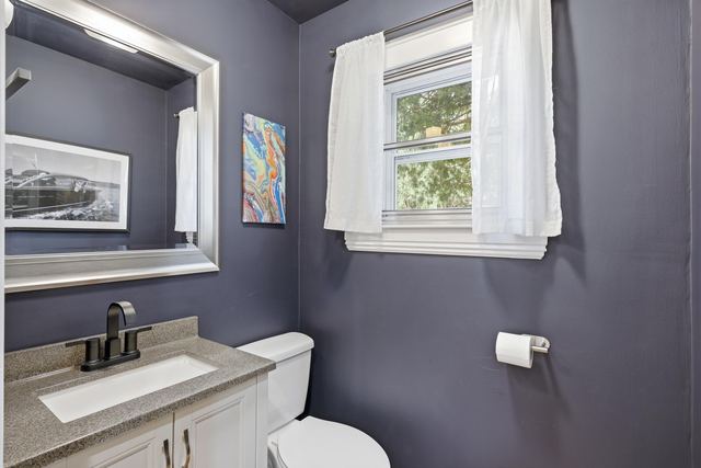Bedroom with sage walls and two windows